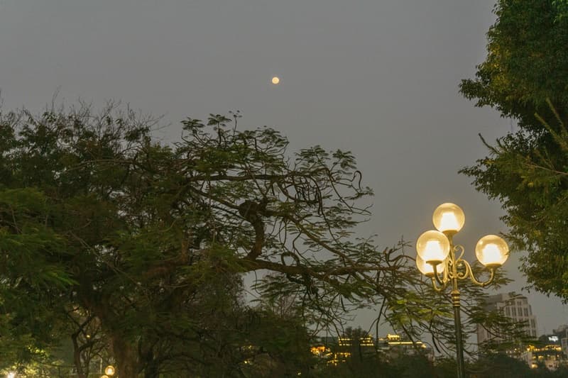 watching a sunset in hanoi next to the lake