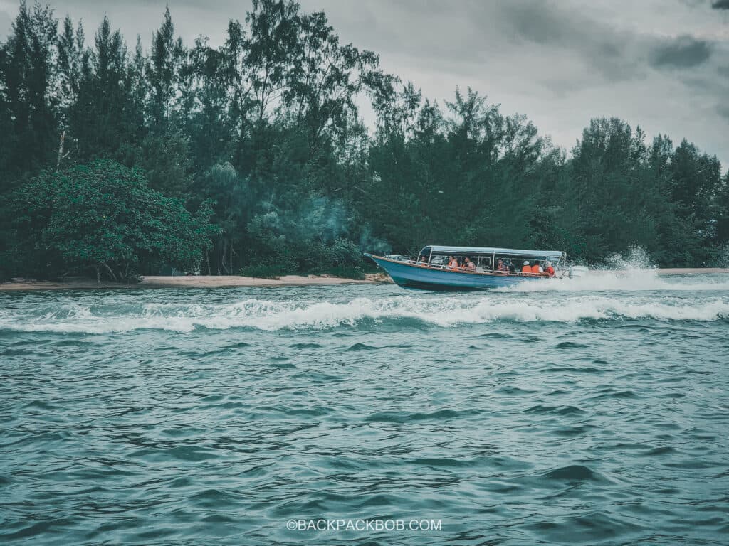 Boat in big waves in open sea water at Langkawi mangrove tour