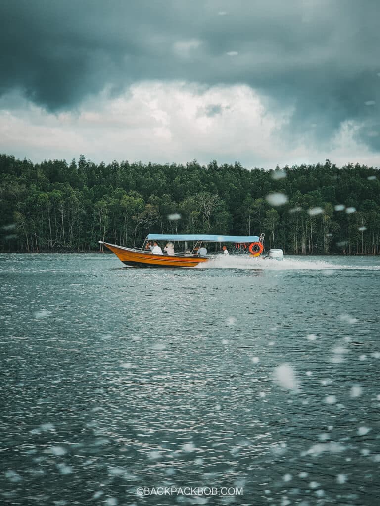 a boat cruises through the Langkawi mangroves on a Malaysia itinerary