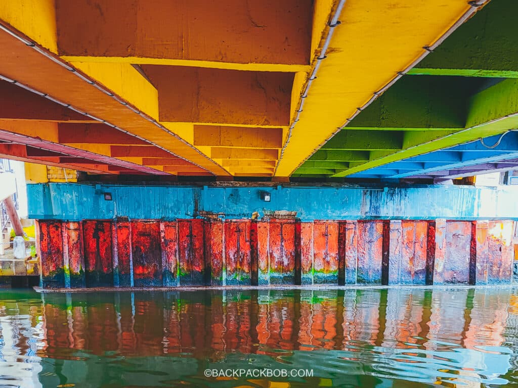 Melaka River Cruise boat goes uder, Old Bus Station Bridge (rainbow bridge) in melaka