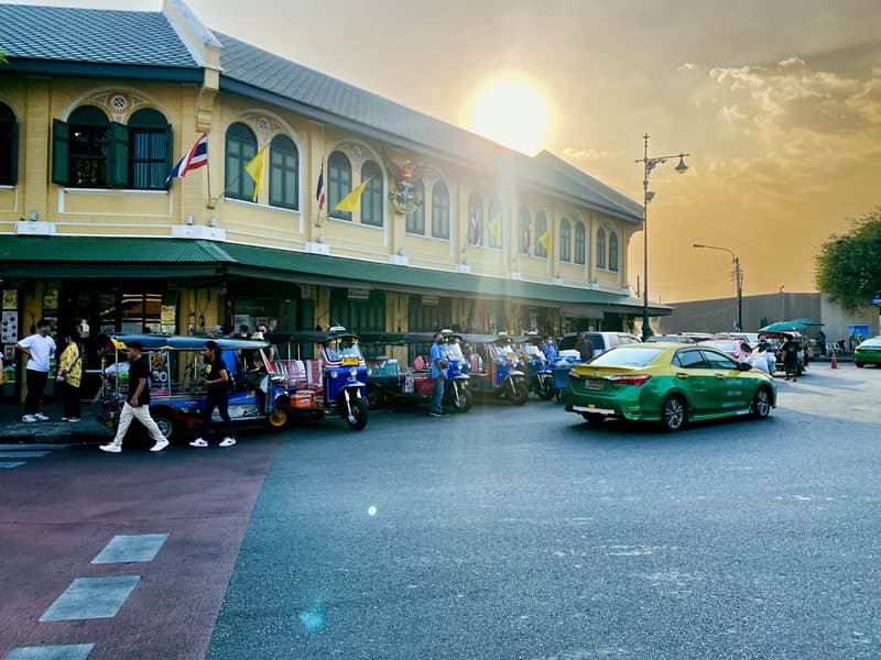 tuk tuk in bangkok with sunset in background