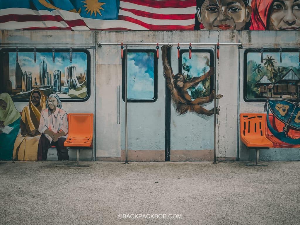An Orangutan swings from the ceiling on a Kuala Lumpur Metro train, as pictures in art form for free