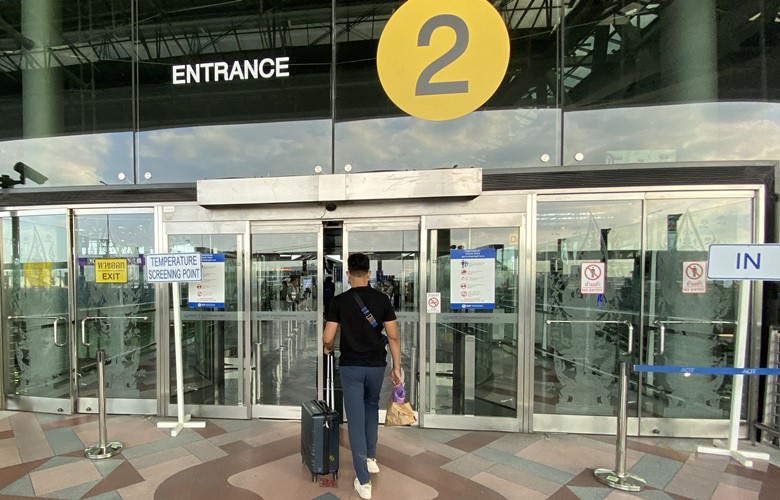 checking in for a flight at bangkok airport coronavirus temperature check