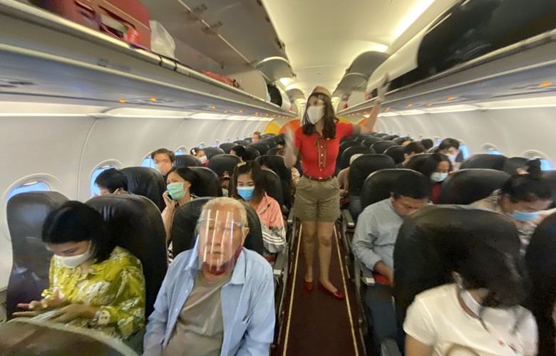 passengers wearing facemasks on a flight during the coronavirus pandemic