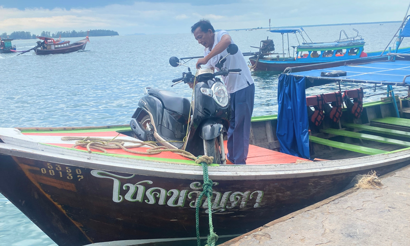 scooter on longtail boat koh libong