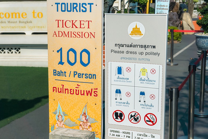 sign at the bangkok golden mount temple with the admission price for tourists