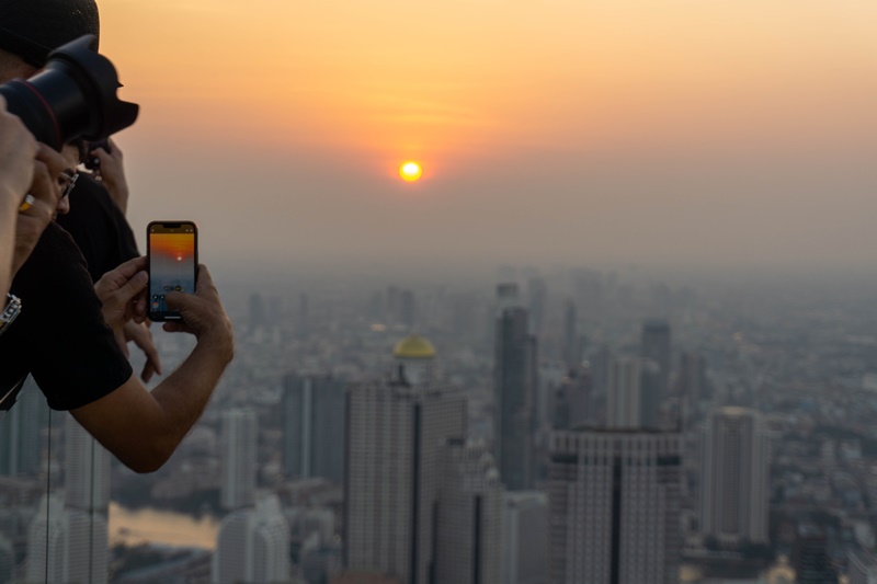 tourists taking photos of the sunset in bangkok