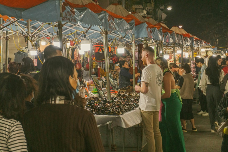 Go to the hanoi weekend night market one of the best things to do in Hanoi Vietnam tourists shop for low cost sunglasses