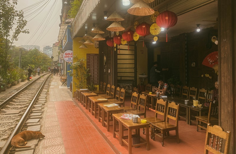 a cafe next to the train tracks at hanoi train street is a good thing to do in hanoi annd the street is open to tourists as pictured