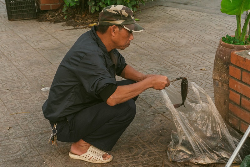 local fisherman catches a fish in Hanoi Vietnam