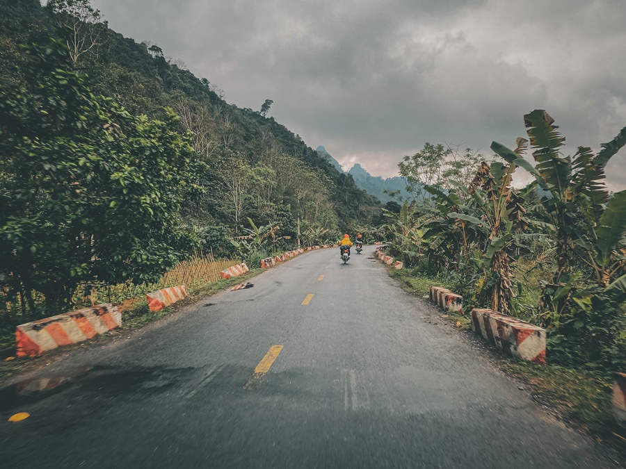 raining on wet road motorcycle on ha giang loop in vietnam 1