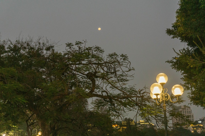 watching a sunset in hanoi next to the lake