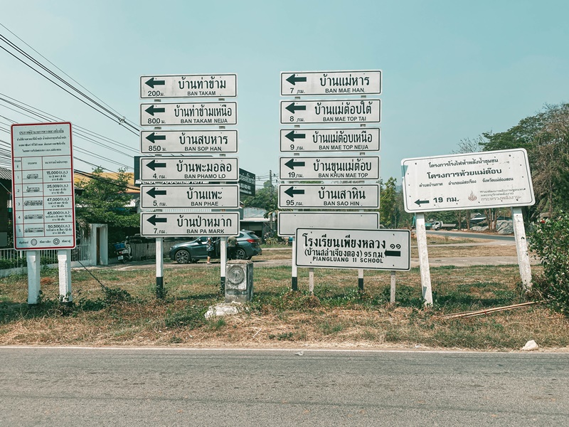 huge signpost with road signs in thailand found on mae hong son loop