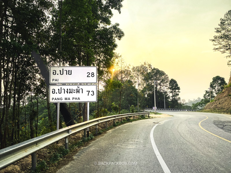 roadsign sign post labeled pai 28 kilometers away on road to pai