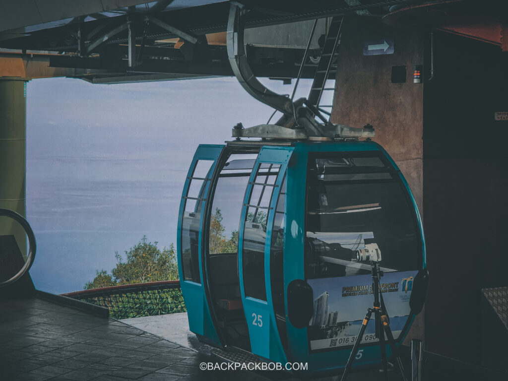 A standard Gondola  with doors open arrives at the middle station on Langkawi Cable Car