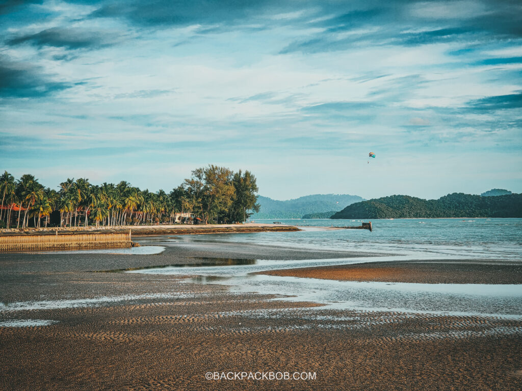 Patani Cenang Beach at low tide, palm trees, parasailing
