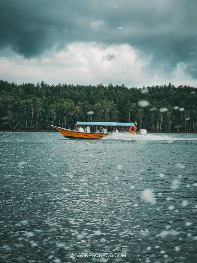 a boat cruises through the Langkawi mangroves on a Malaysia itinerary