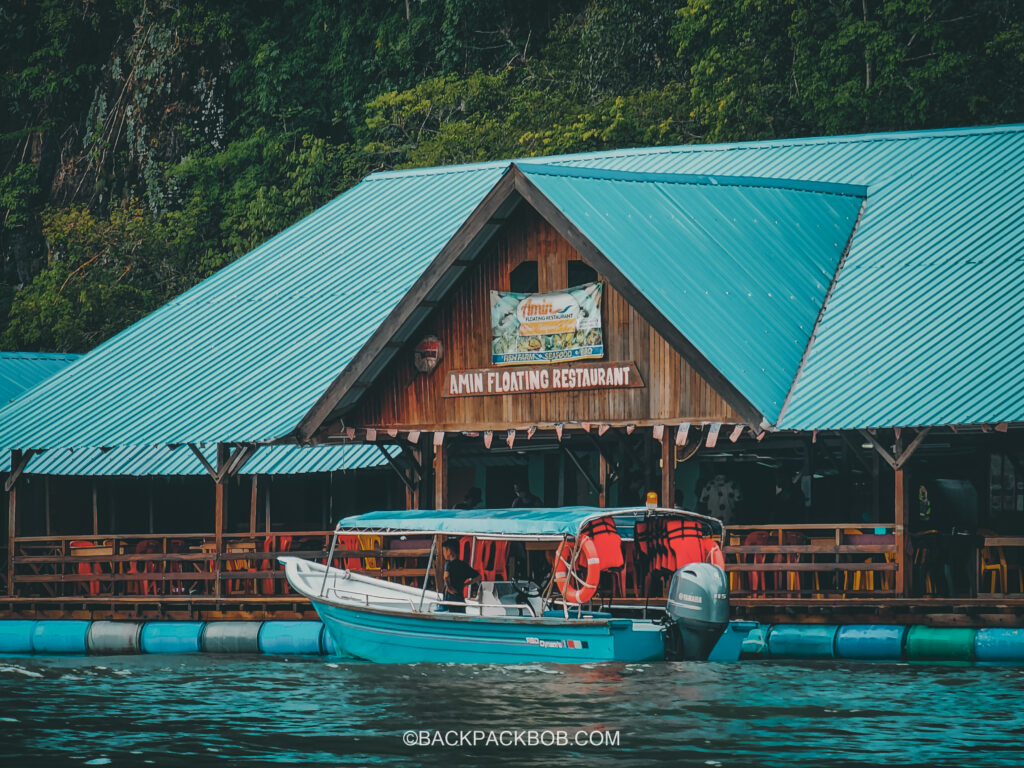A tour boat docks at the floating restaurant in Langkawi Mangroves