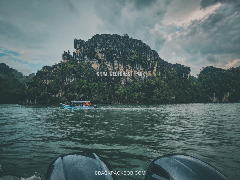 A small boat takes tourists to see the kalim goeforest park sign on a tour