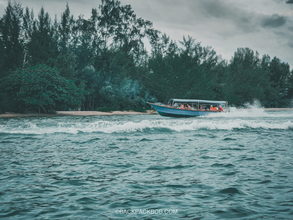 Boat in big waves in open sea water at Langkawi mangrove tour