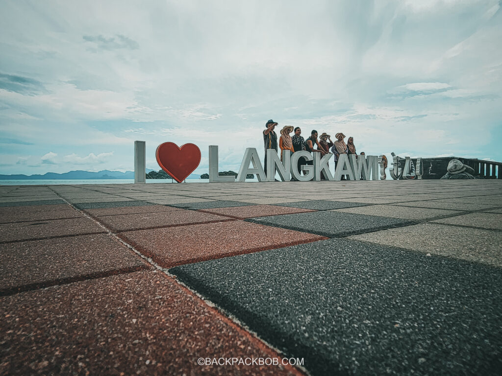 Tourists on the Langkawi Mangrove tour taking photos at Tanjung Beach near mangroves start point