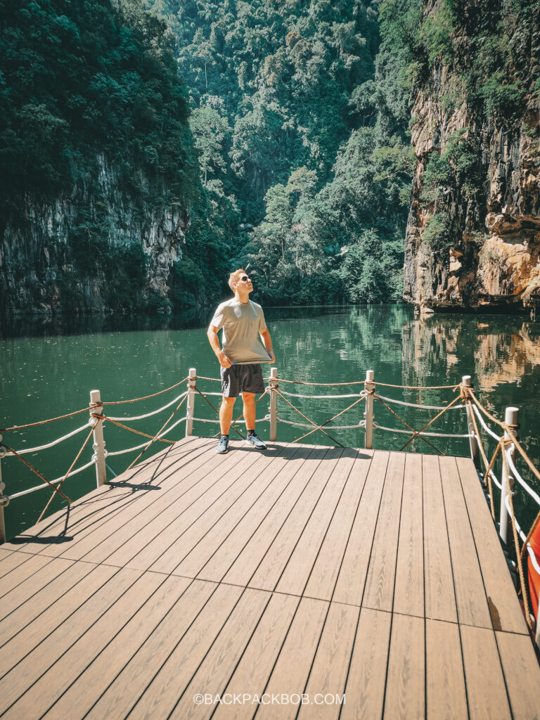 Backpack bob awkwardly standing at Ipoh Lake having a picture taken as part of the Malaysia itinerary