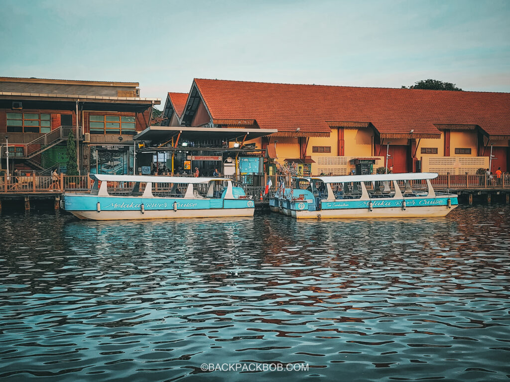 blue Melaka river cruise boats moored at the harbor spice jetty garden tour start point