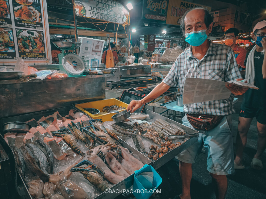 A vendor at the Jonkers Market preparing fish Jonkers Street Market | Jonkers Street Weekend Market | Jonkers Street Night Market | Jonkers Street Market in Melaka