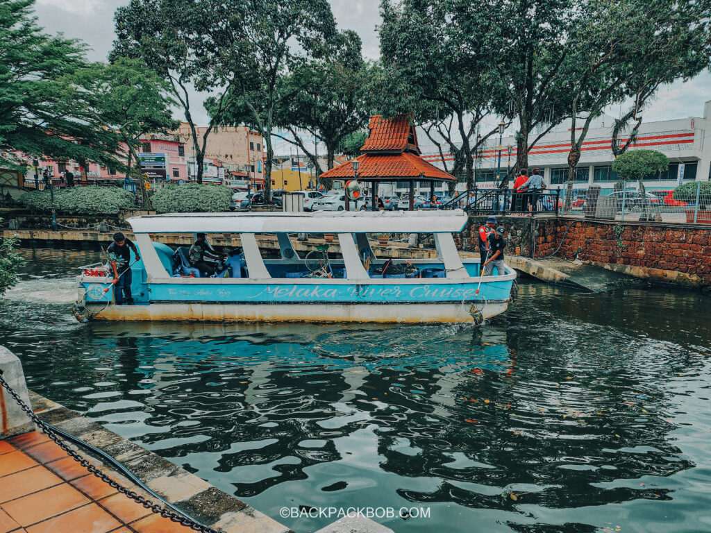 Melaka River Cruise Boat Company is using the blue boat to scoop and clean trash out from the river in the morning to keep Melaka river clean