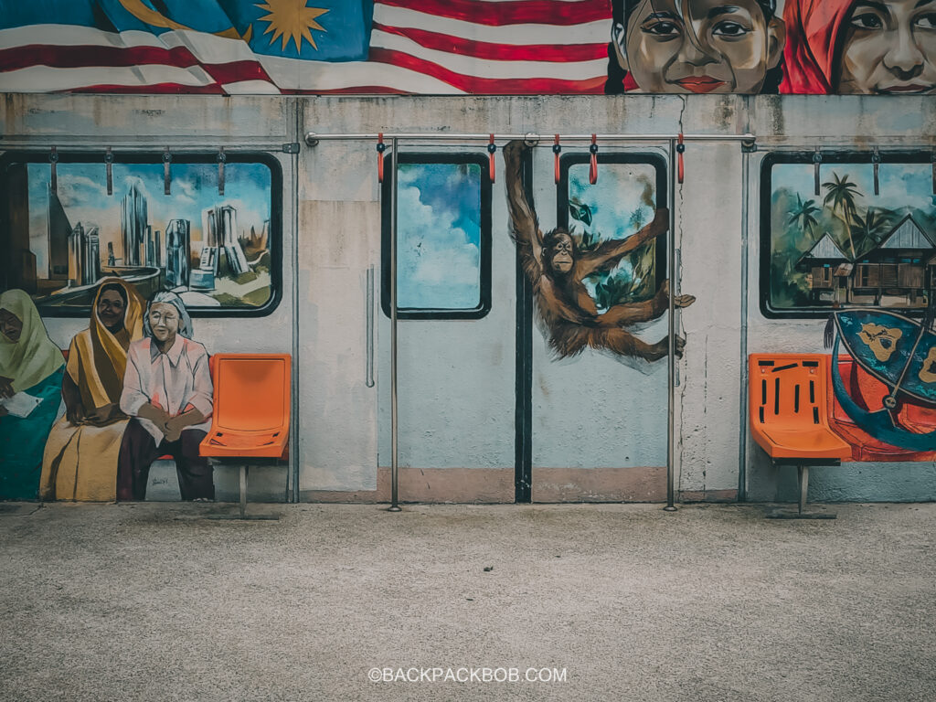 An Orangutan swings from the ceiling on a Kuala Lumpur Metro train, as pictures in art form for free