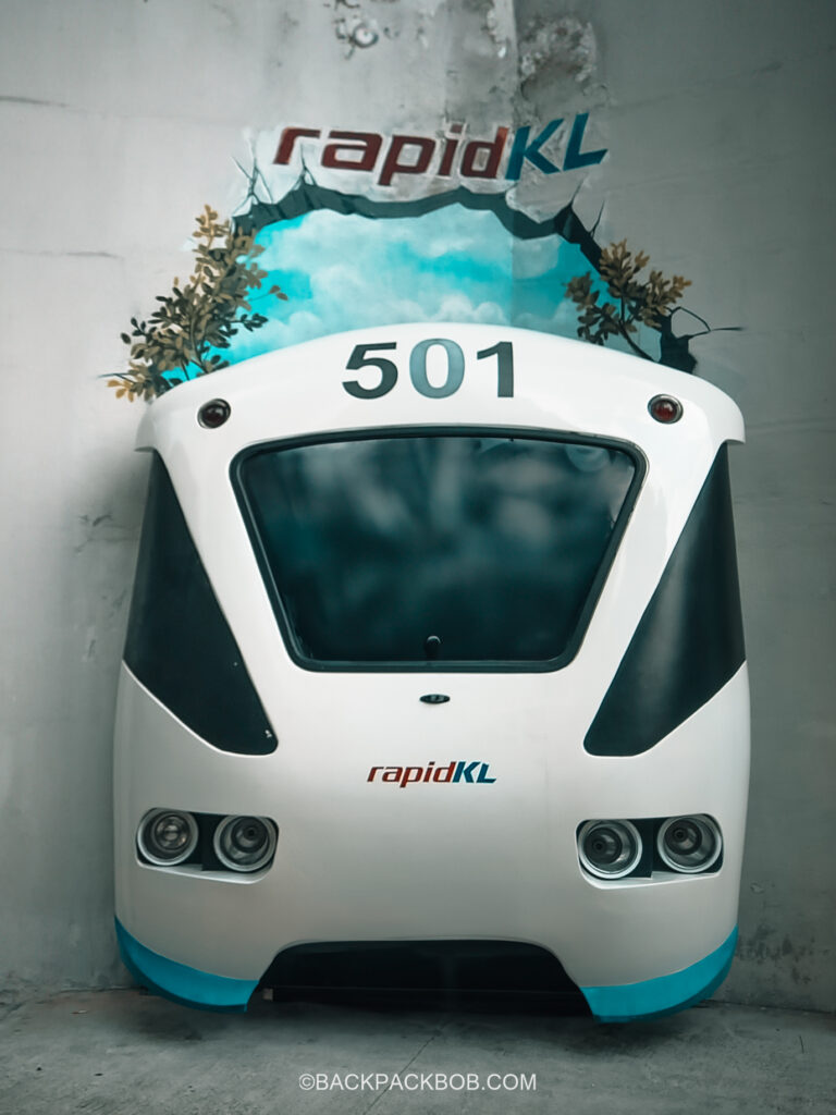 A Rapid KL Train is displayed as a free attraction outside the Masjid Jamek train station in Kuala Lumpur