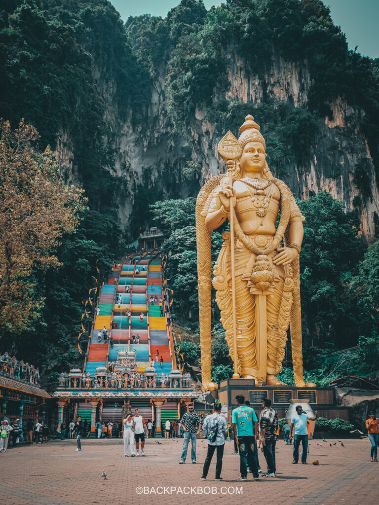 Golden Statue and Rainbow Staircase outside the Batu Caves in Kuala Lumpur, a free thing to do in Kuala Lumpur
