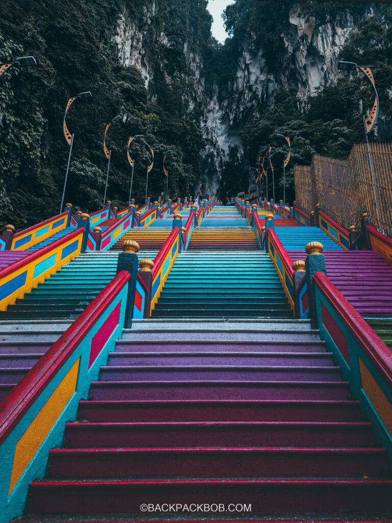 Colourful staircase at Kuala Lumpur Batu Caves the perspective is from the bottom of the steps looking up. THere are no people on the stairs the stairs are closed
