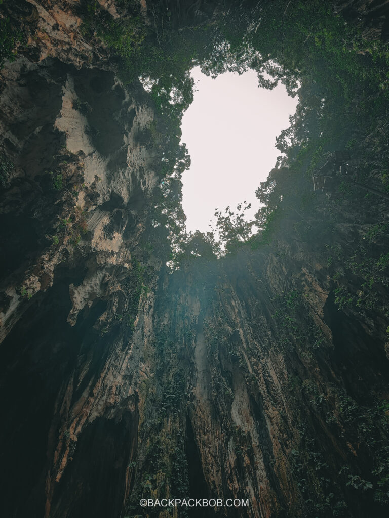 An opening in the roof of Batu Cave lets light inside