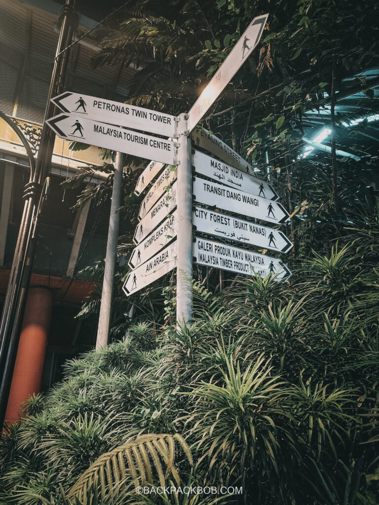 A signpost located on the free Kuala Lumpur walking train gives directions to the Petronas Twin Towers and the Malaysian Tourism center
