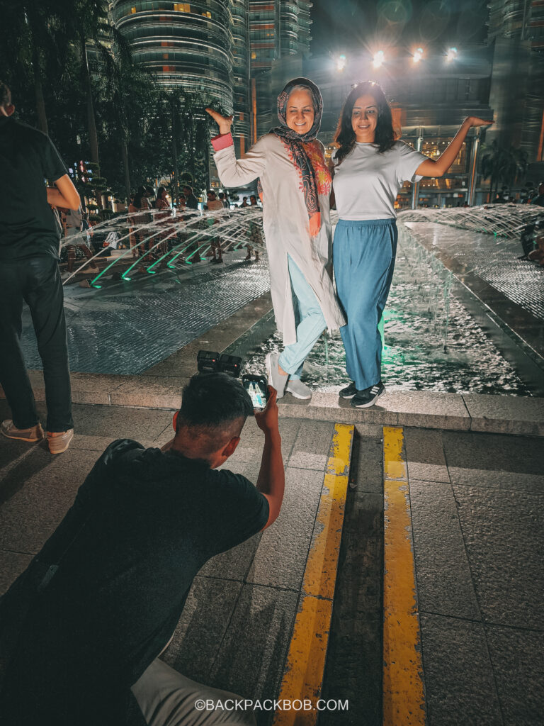 Tourists Posing For Professional photo service at Petronas Towers.