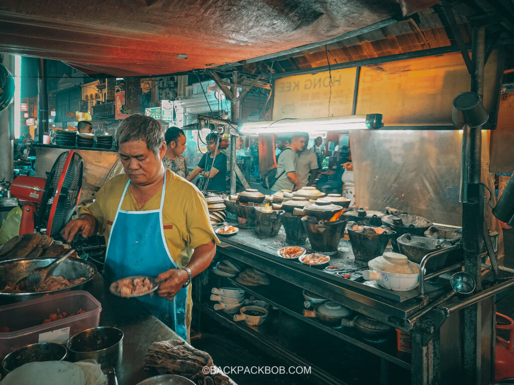 A chef coos on a grill at at Kuala Lumpur street haker center stall