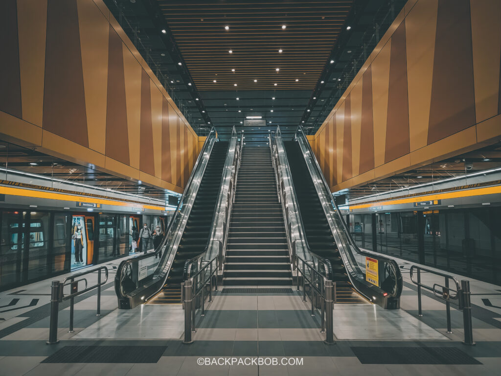Kuala Lumpur Yellow Train Line is the cheapest route to free KLCC. The photo taken inside the newly built station has dual escalators leading up to the first floor and there is a train platform either side. The station is covered with yellow panels