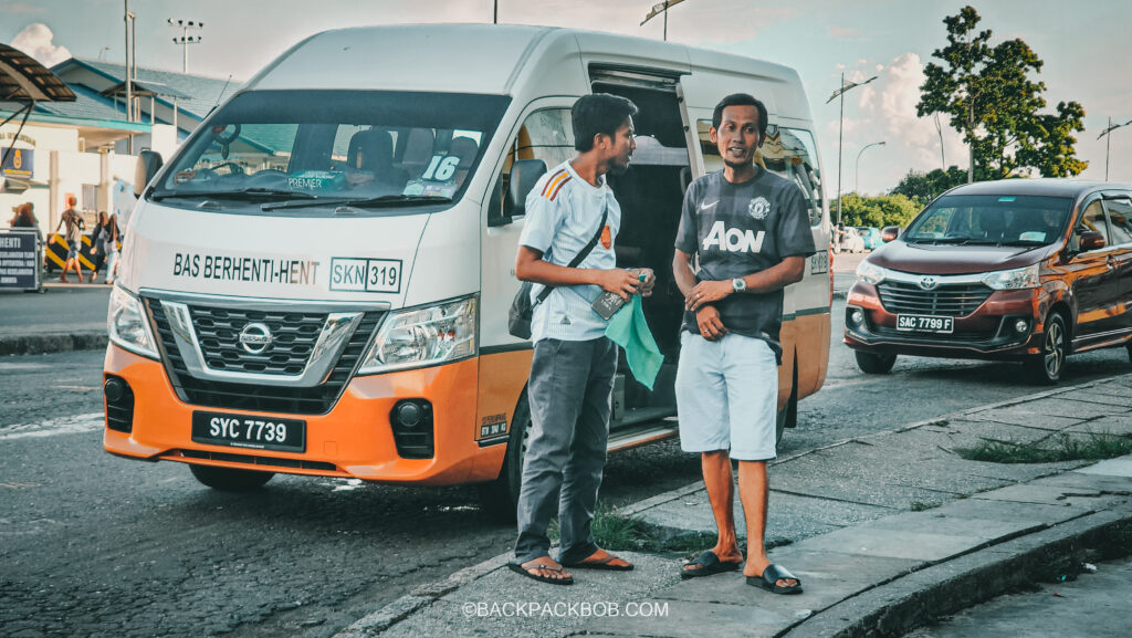 The orange minivan show in the picture transports guests from Sandakan to Sepilok Orangutan center