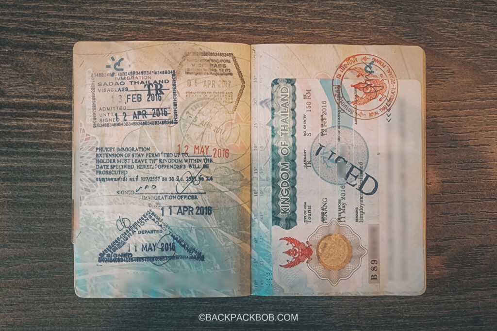 UK Passport with tourist visa for Thailand and entry stamps from visa run