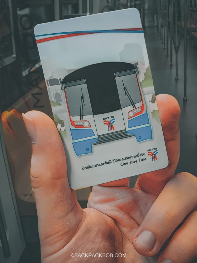 A passenger is holding a BTS Skytrain ticket One Day Pass