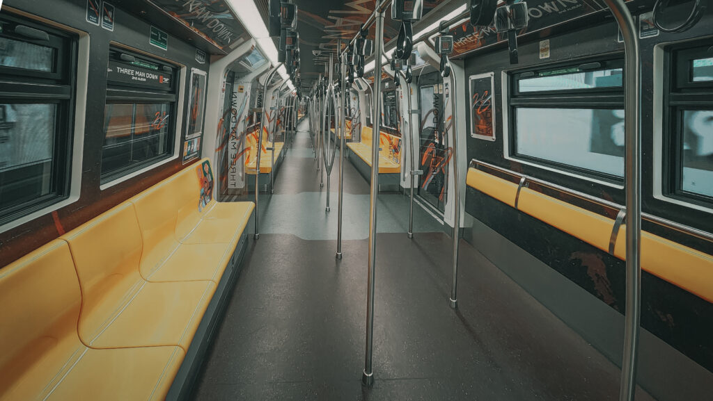 Interior of BTS Train Carriage with yellow seats and standing area without people on board