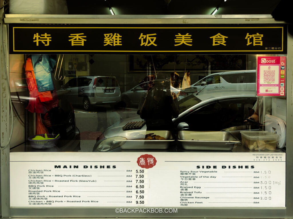 A Chinese food cart selling duck in Ipoh at a hawker center, the menu is in Chinese and English