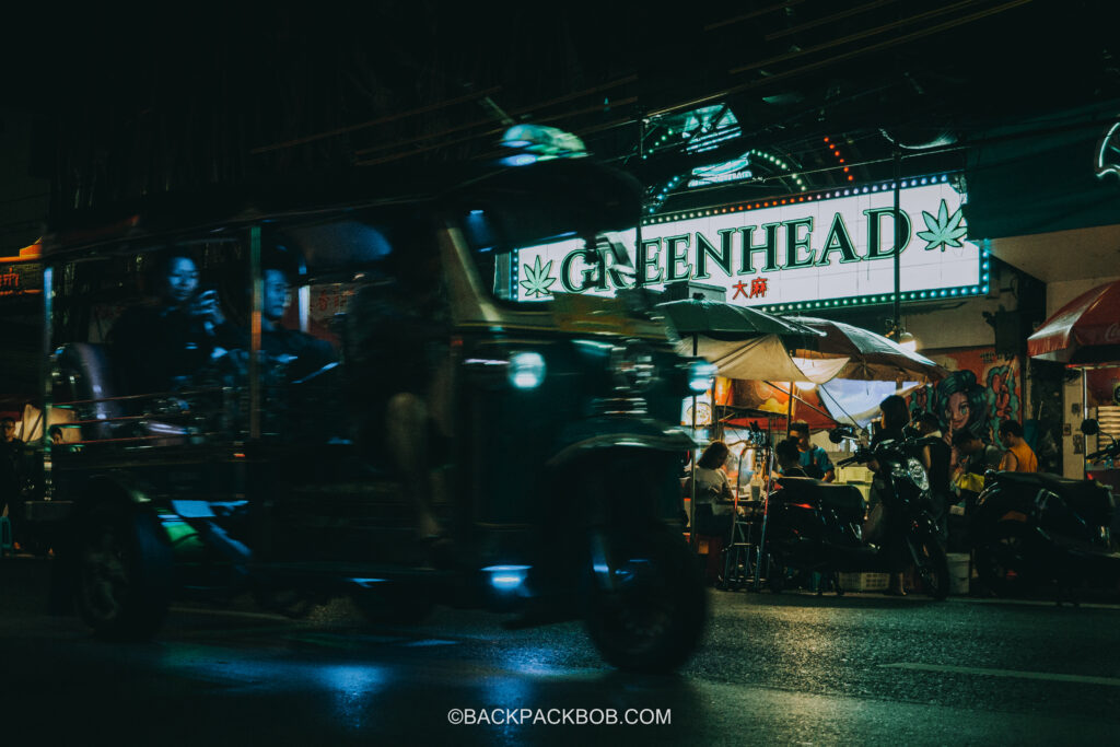 A tuk-tuk passes by a legal cannabis shop and dispensary in Old Town Bangkok, China Town