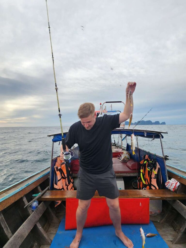 tourist catching fish in koh phi phi